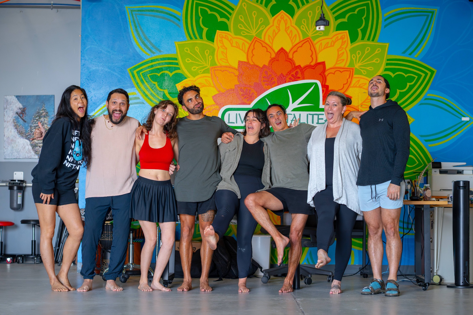 The whole group together with arms around each other, laughing